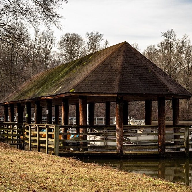 Boat dock on a pond in a park.